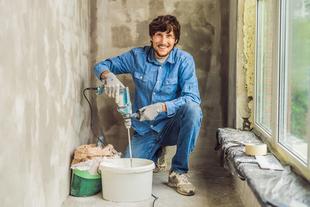 A tradesperson preparing material for interior finishing